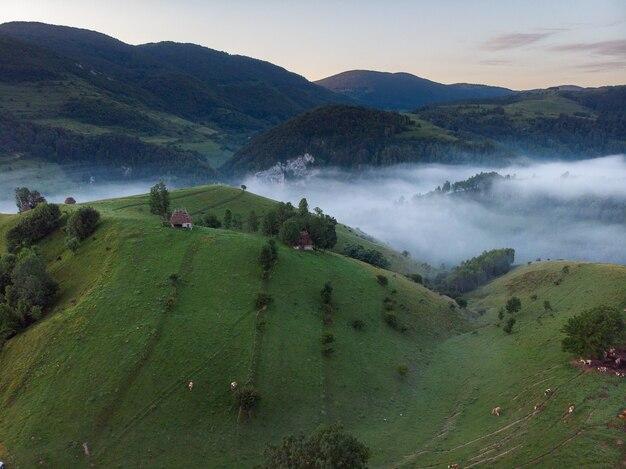 Aerial shot of a small house in an amazing mountain landscape in Transylvania, Romania