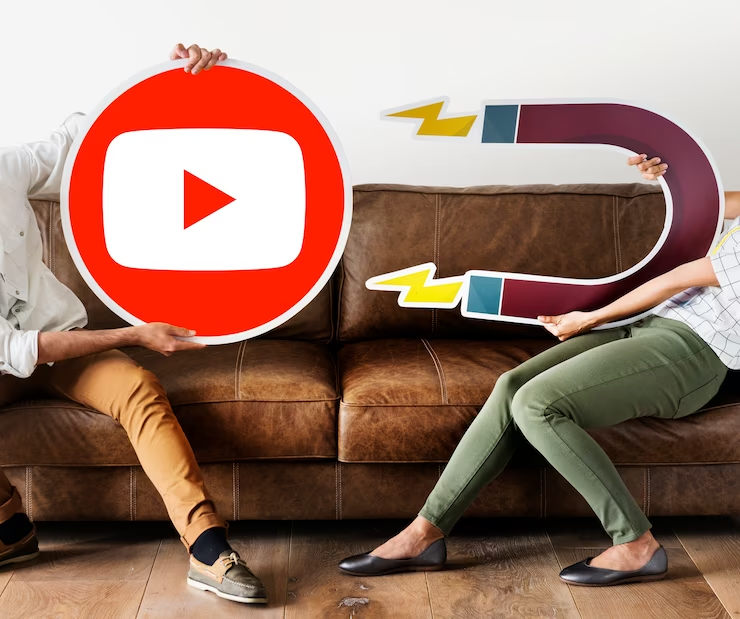 A Person is Holding a YouTube Icon While Another is Holding A Magnet Cutout