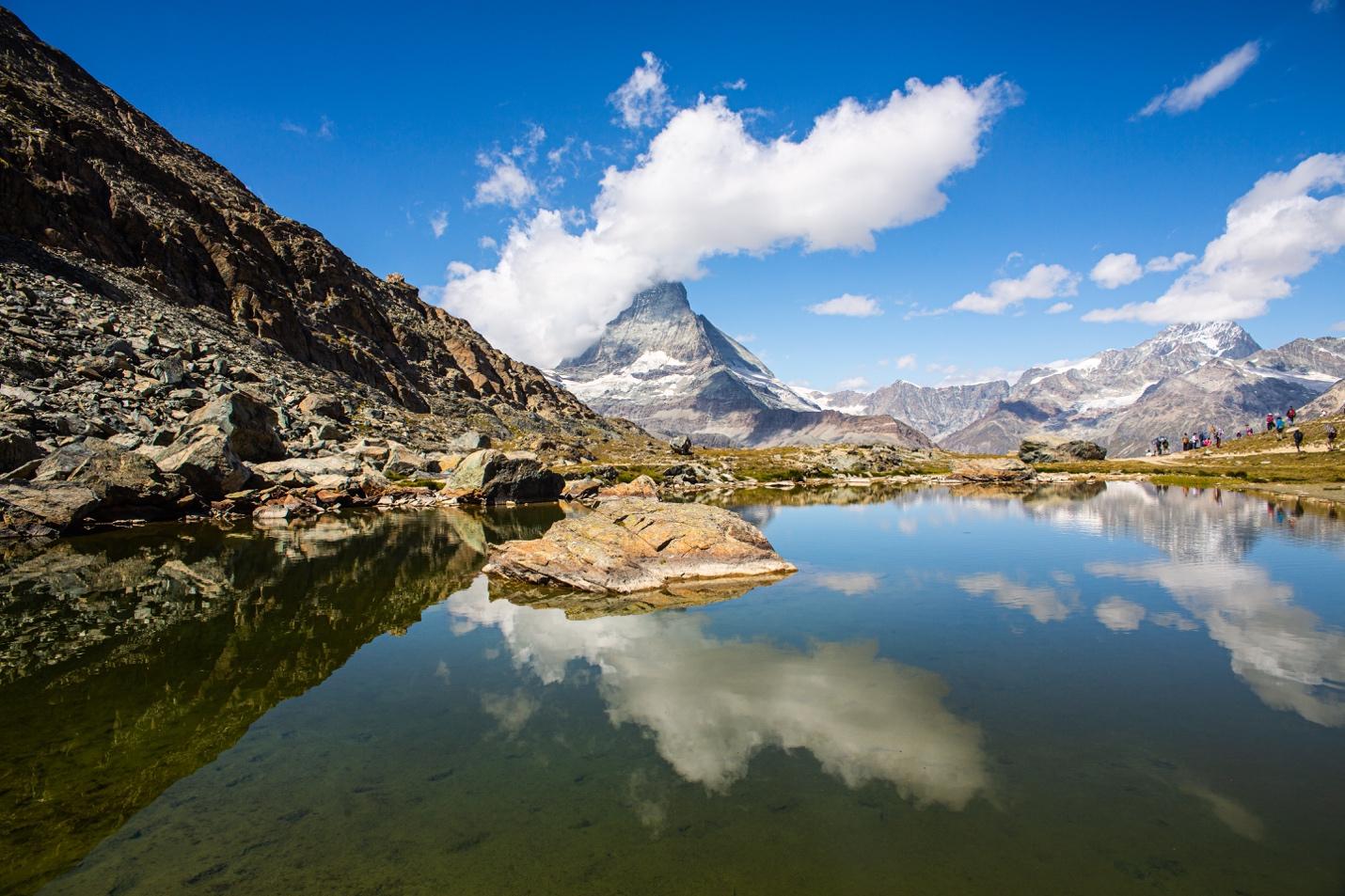 A mountain lake with a mountain in the background

Description automatically generated