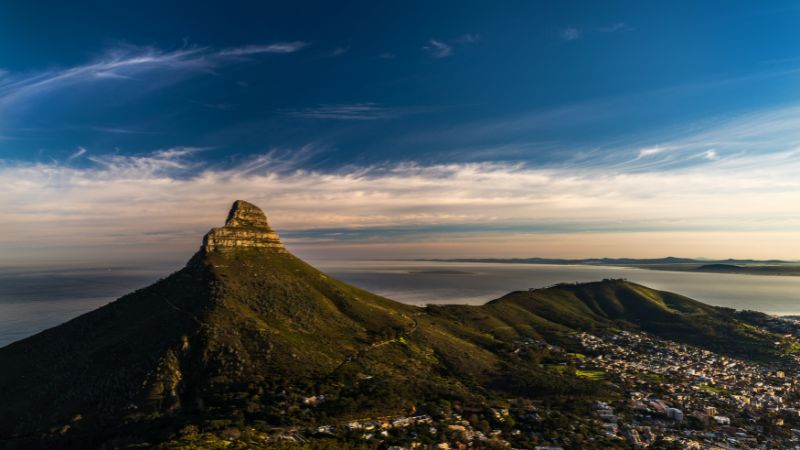 Free things to do in Cape Town - An aerial view of Lion's Head, capturing the mountain and surrounding area during sunset.