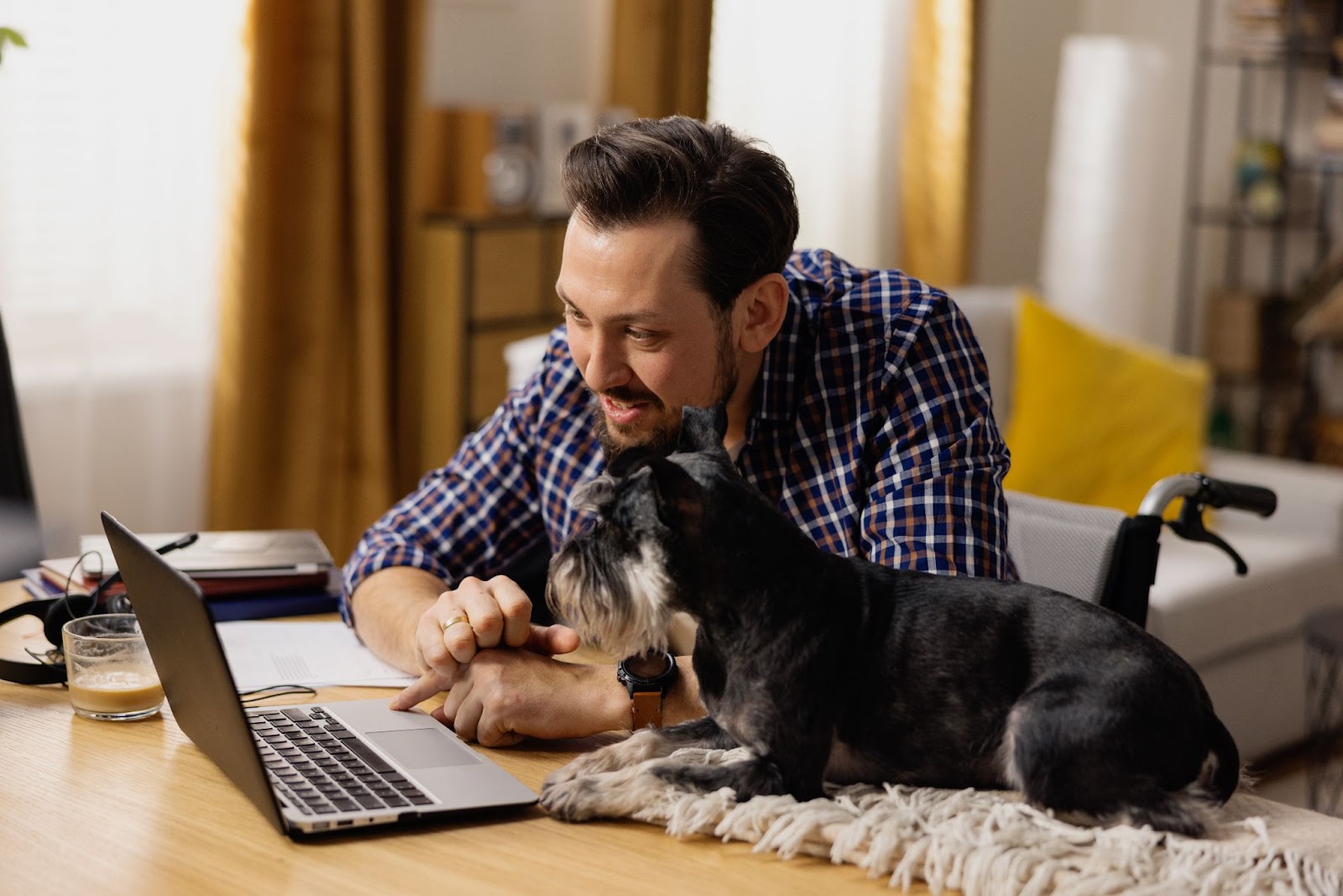 dog and owner in front of laptop