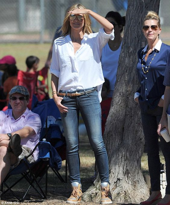 Picture showing a a lady rocking  a chic soccer mom outfits with jeans and a white shirt