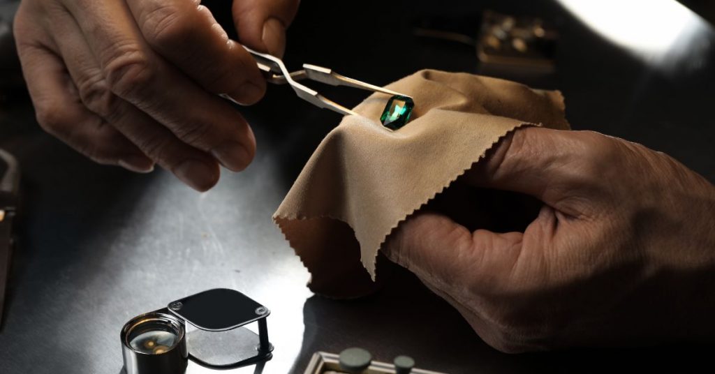 Professional Jeweler Working with Gemstone at Table Closeup