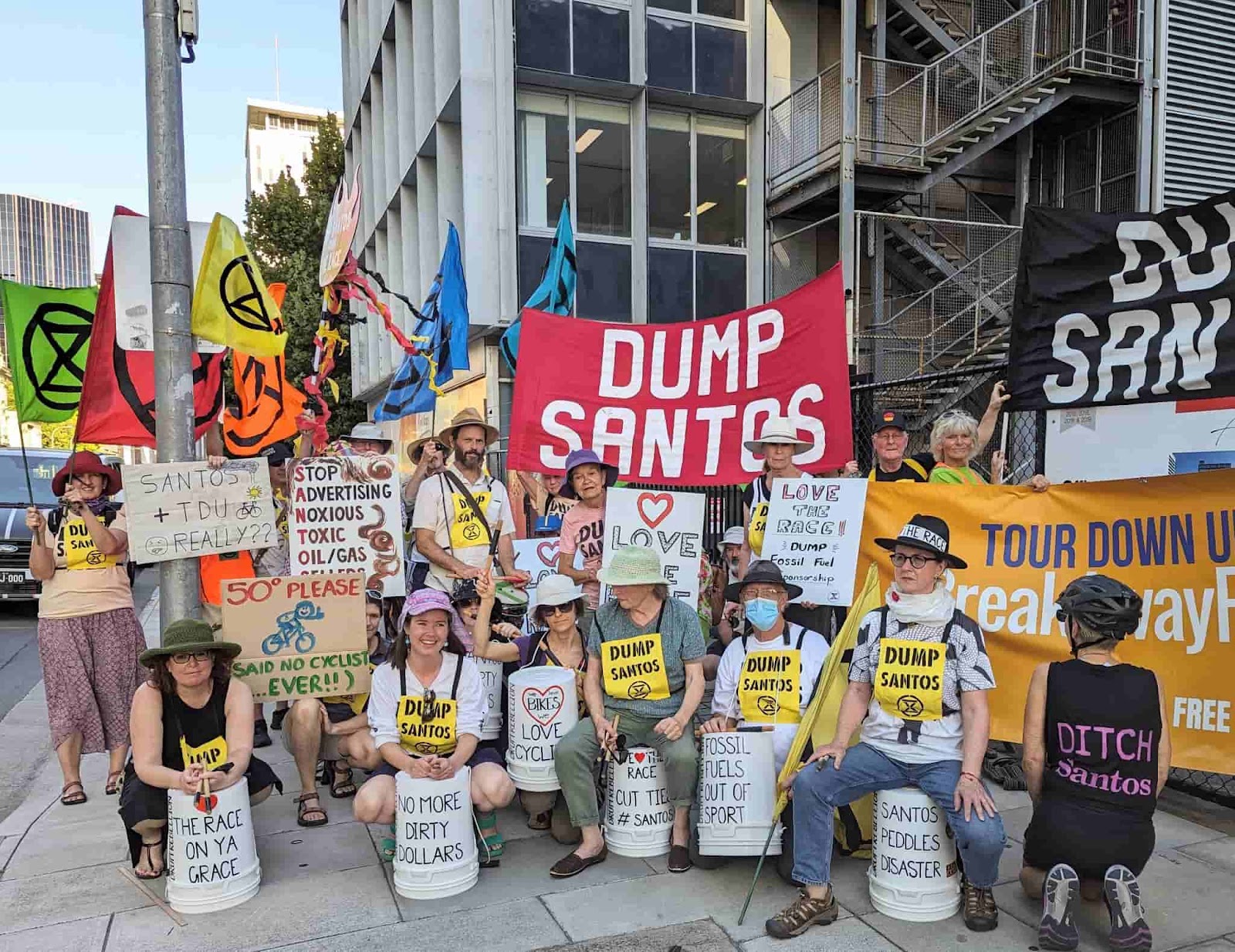 Rebels pose on the street with drums and dump santos signs