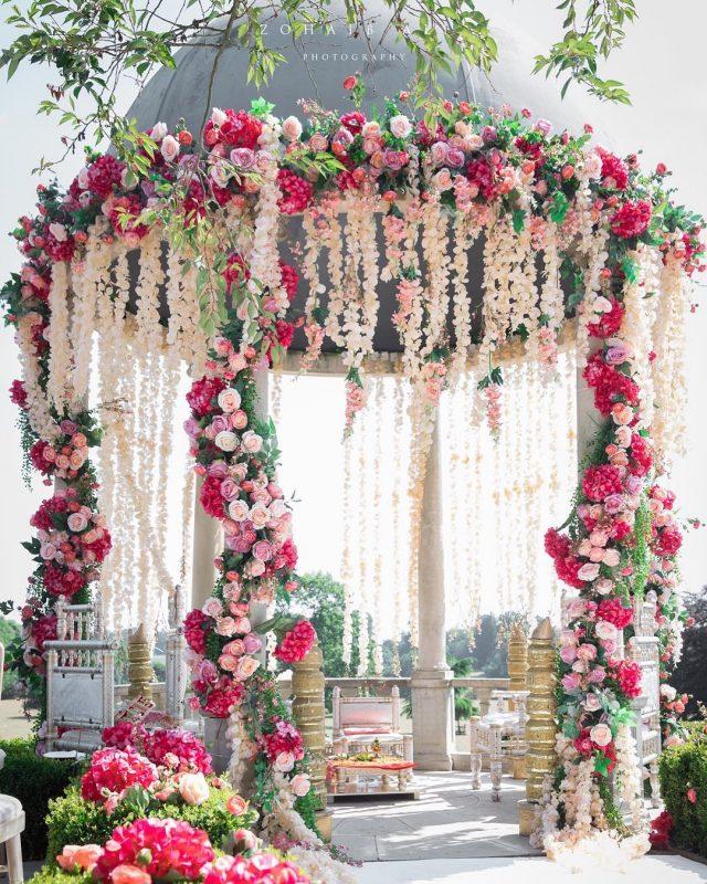 A gazebo with flowers and garlands

Description automatically generated