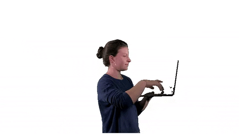 GIF of a lady typing on a laptop in her hand
