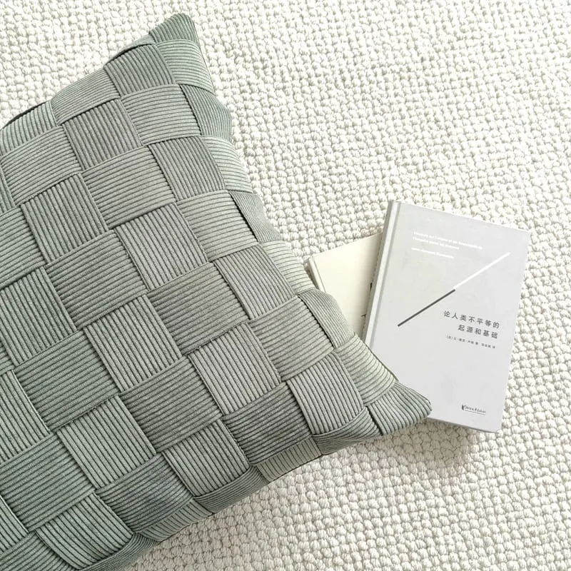 Textured green corduroy cushion with a unique ketupat-inspired pattern