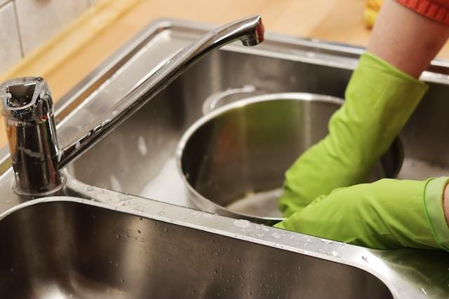 a woman making sure to keep grease out of her drains.