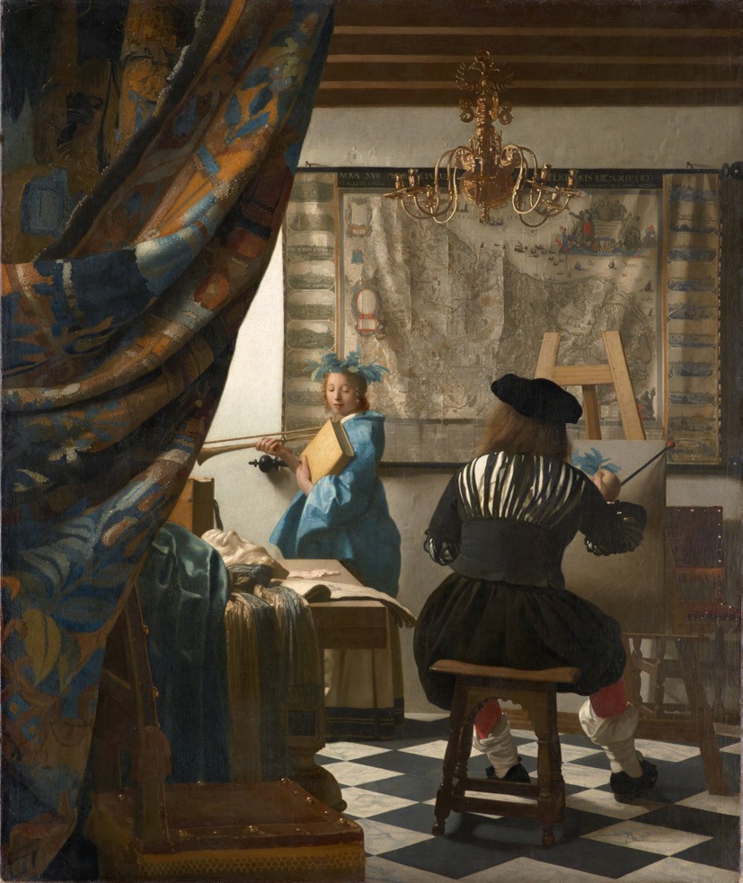 An artist paints a young girl holding a book and wearing a blue dress with blue feathers in her hair. There's a heavy curtain pulled aside in the foreground, a chandelier hanging from the ceiling and a large tapestry hanging in the background. 