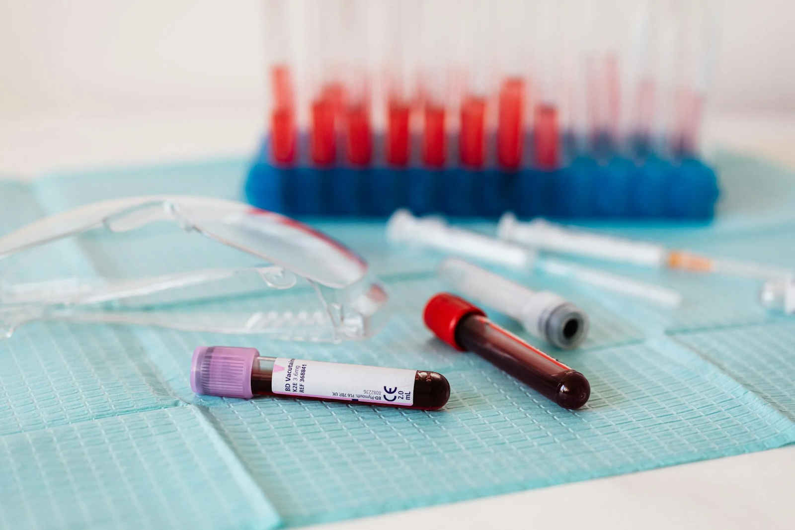 Vials of blood next to lab equipment