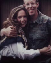 Thomas Carroll and his wife hug in a posed picture