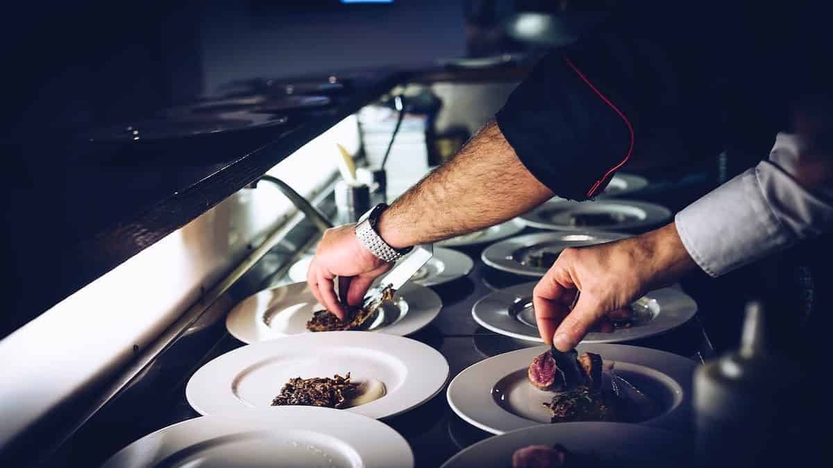 person preparing cooked dish