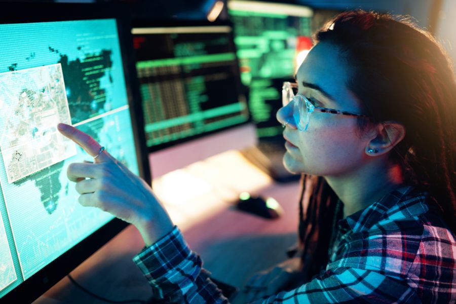 Woman pointing at a screen with digital maps.