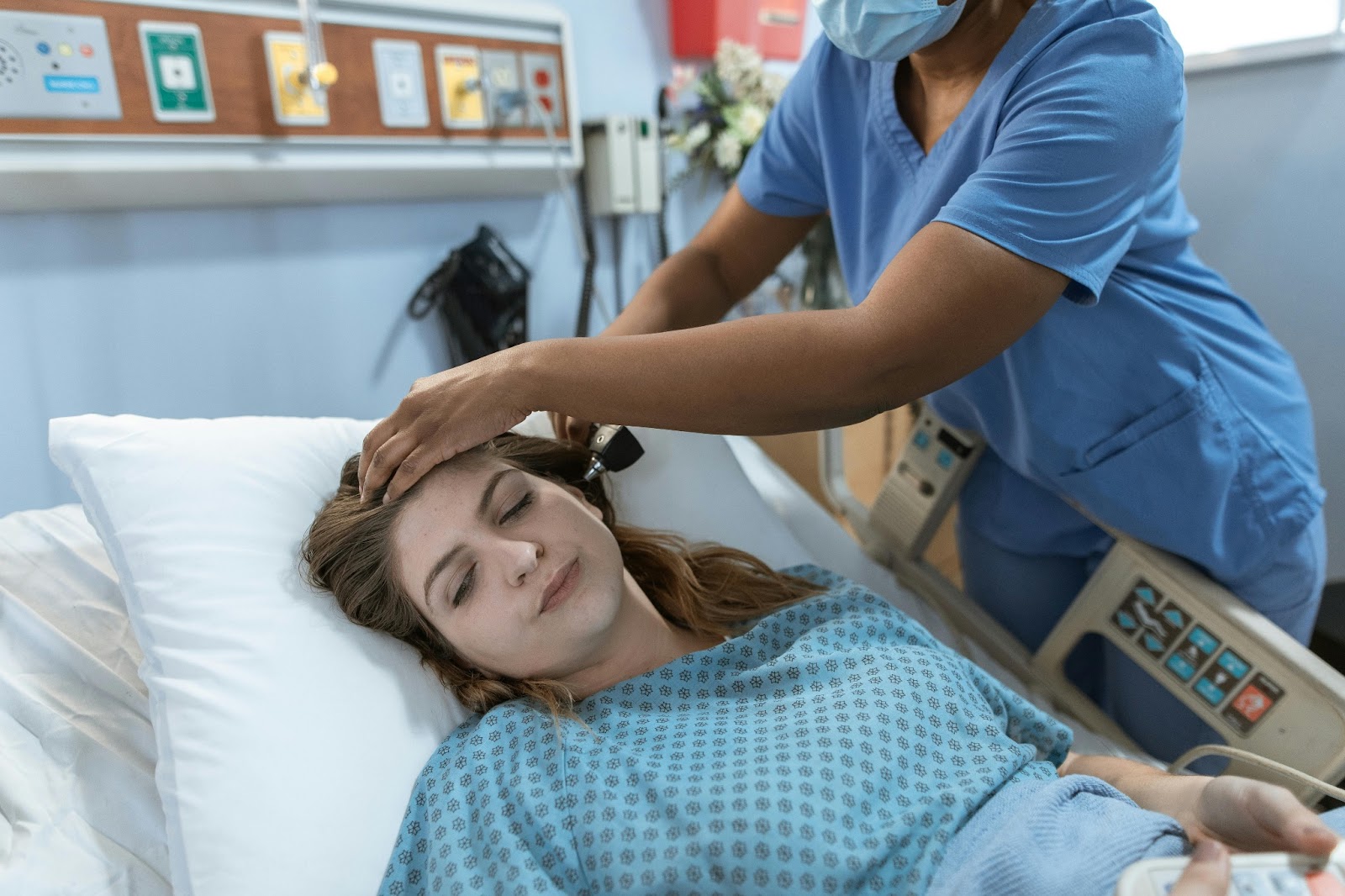 A nurse practitioner examines a patient.