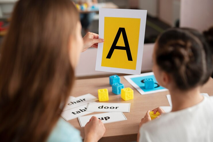 A compassionate psychologist assisting a young girl in speech therapy for dysgraphia.