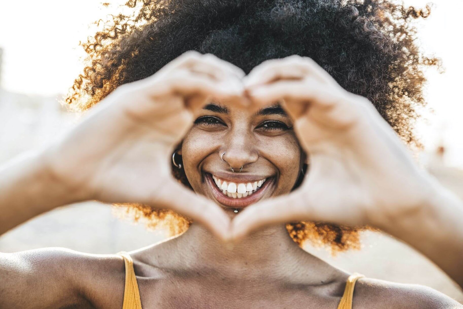 a girl making heart by hand