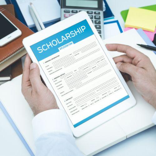 Hands holding a tablet with a scholarship application

Description automatically generated