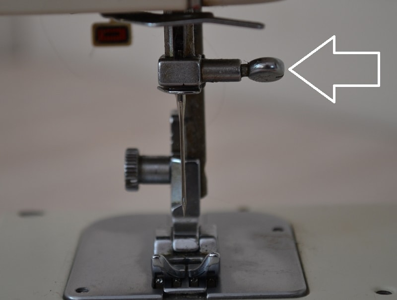 Sewing machine needle tightening screw