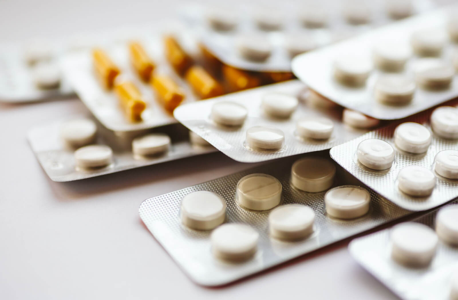 An assortment of medications on a white surface.
