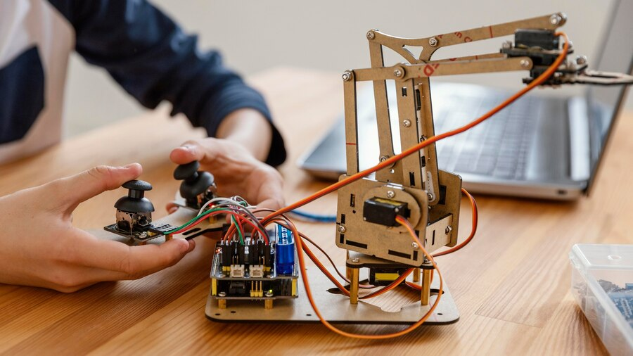 Child building robot at Engineering Summer School.
