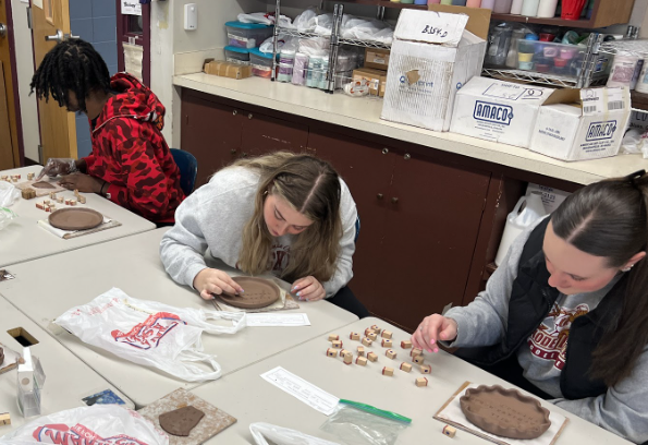 image of stidents making healthy living positive mantra pottery