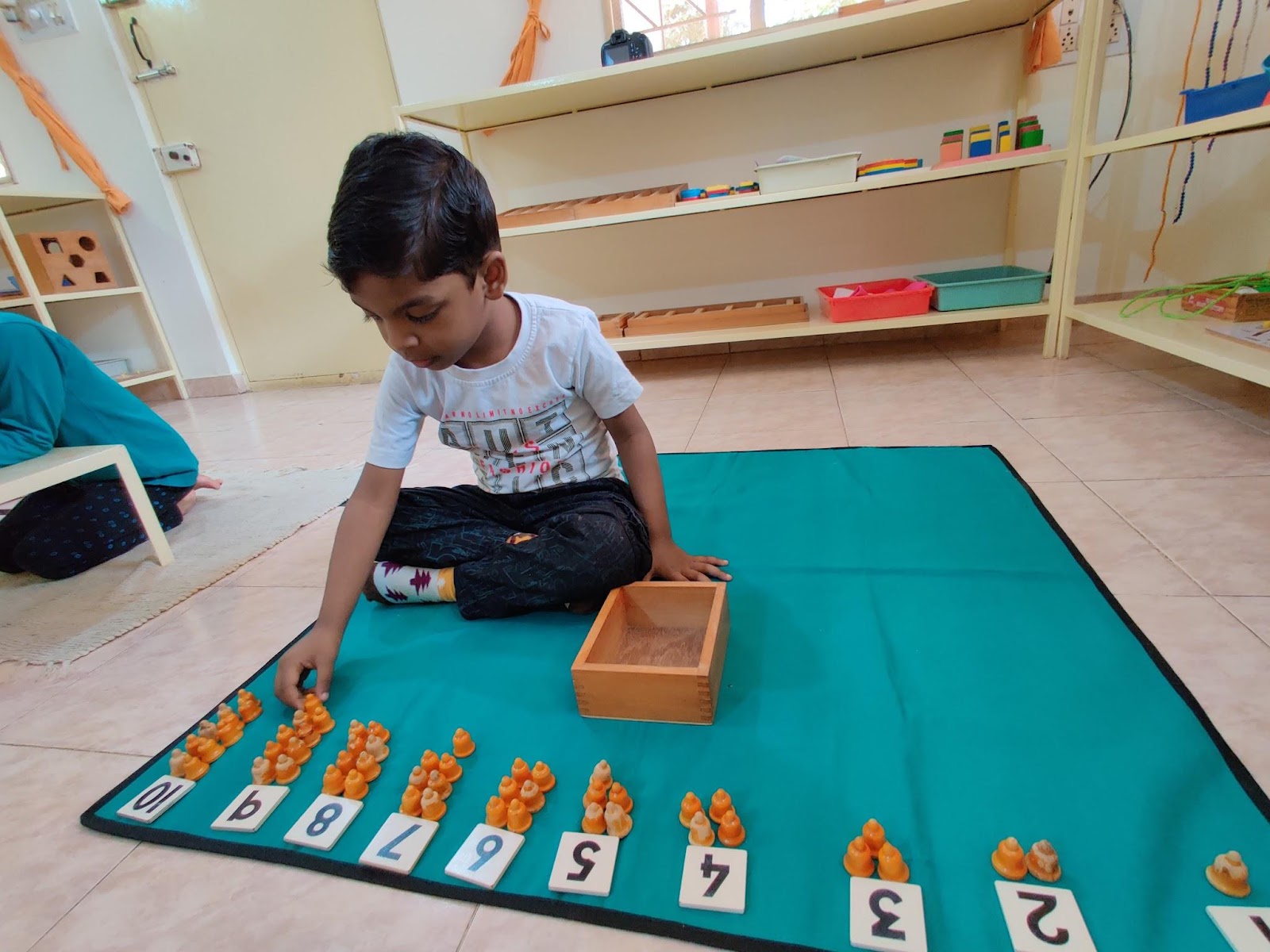 Child playing with number games - Montessori Materials