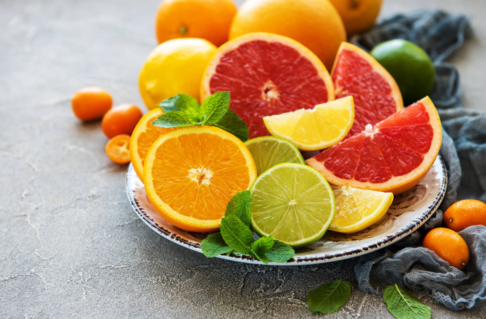 An assortment of various sliced citrus fruits on a plate.