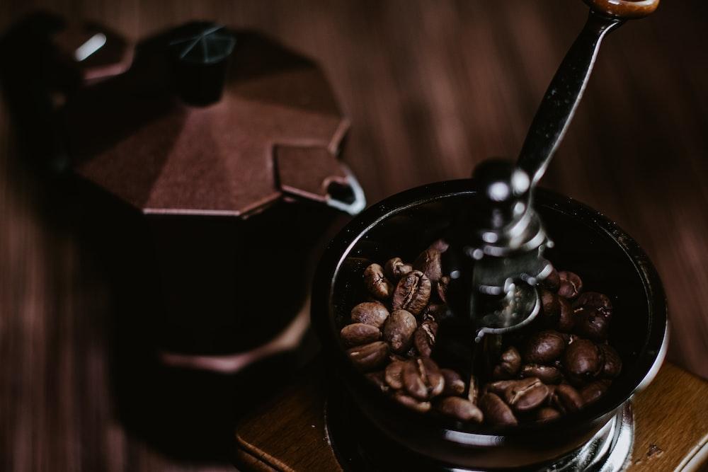 coffee beans in black ceramic mug