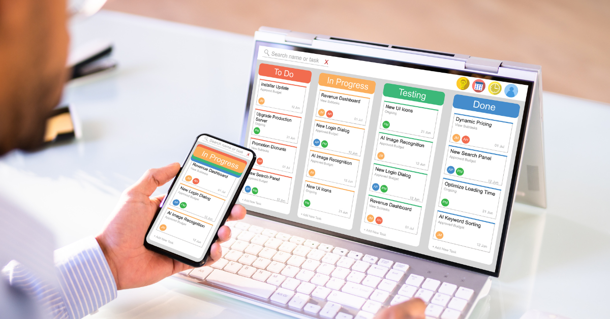 Person using agile project management software on a laptop and smartphone