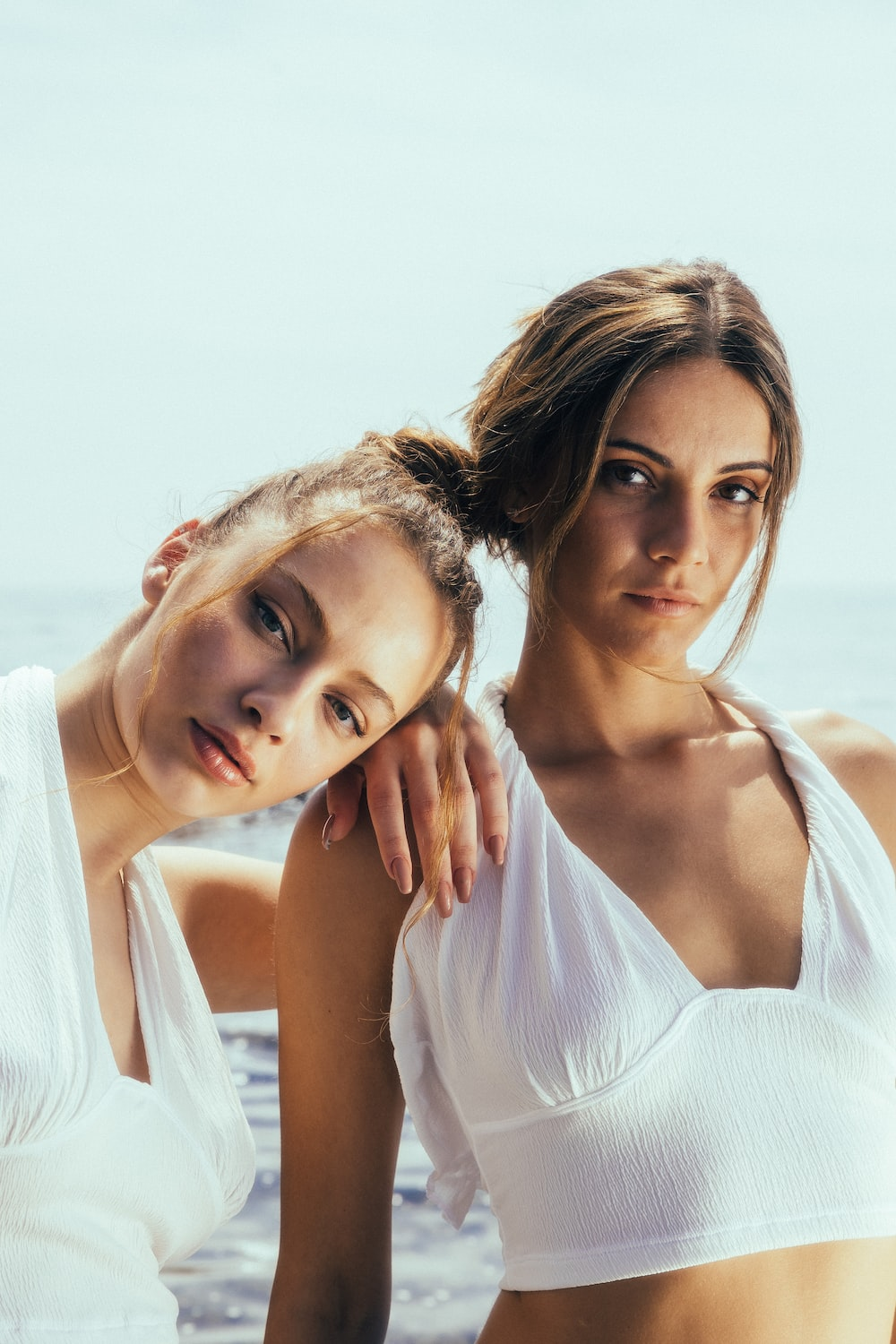 Two girls posing in white
