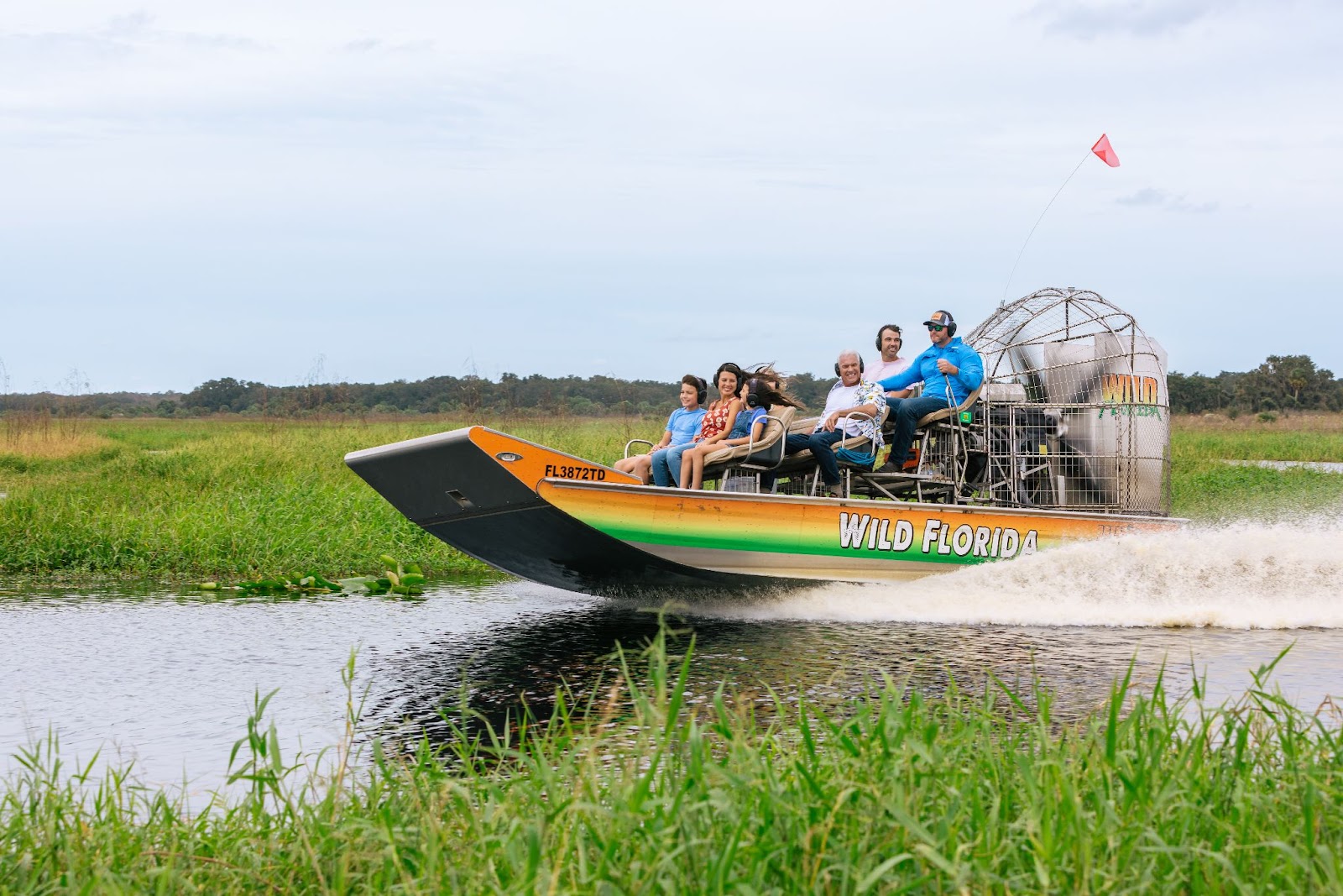 A family take a trip on an airboat tour at Wild Florida