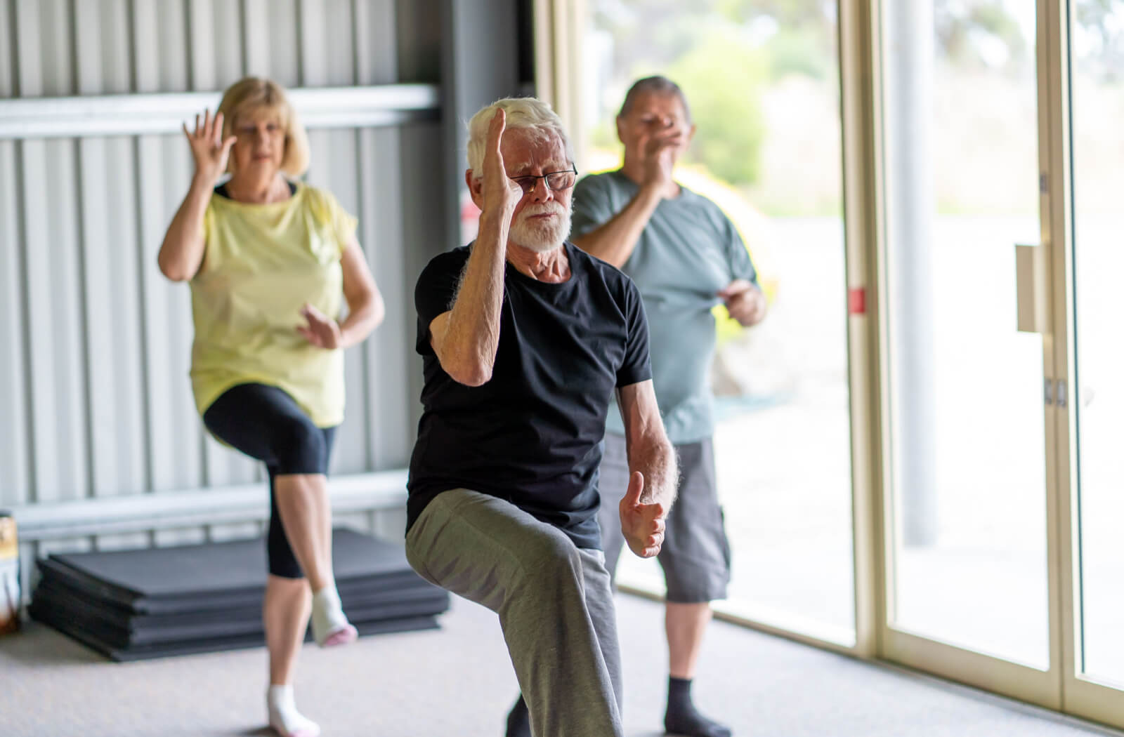 A group of seniors participating in a tai chi class