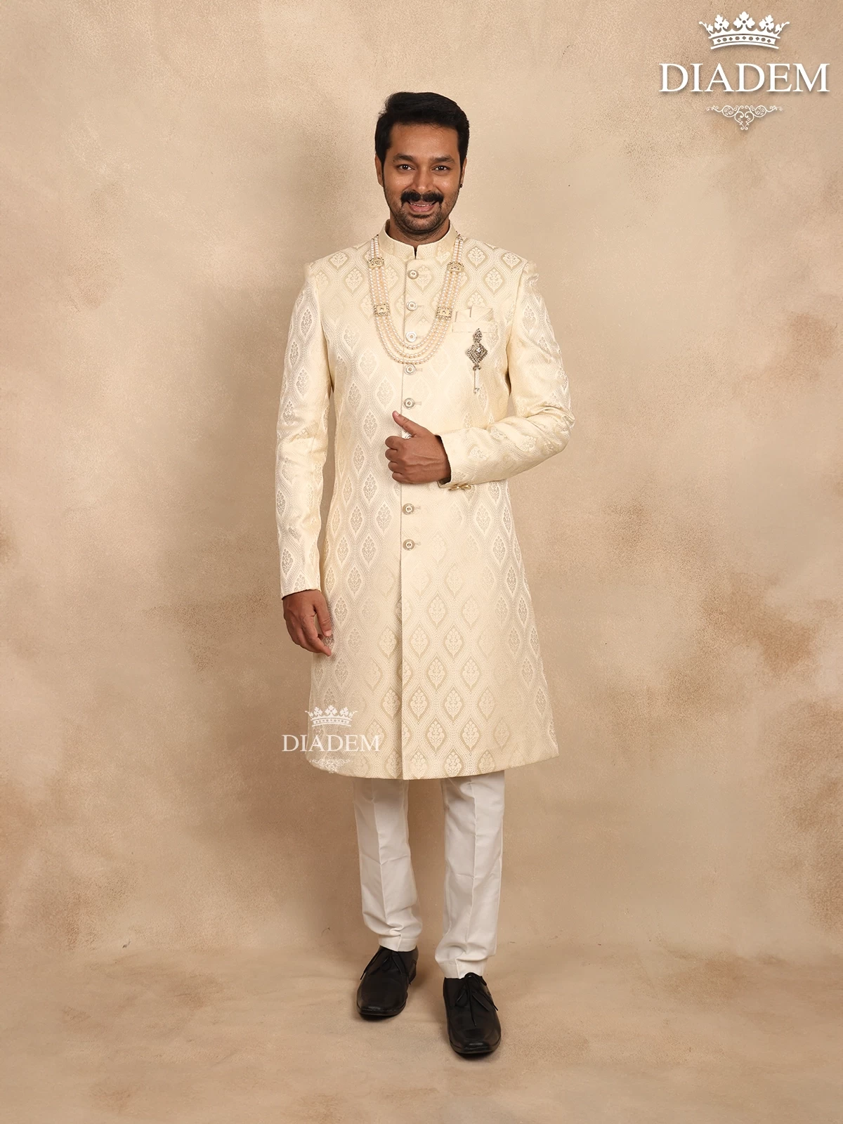Cream Raw Silk Sherwani Suit Adorned with Floral Embroidery, Paired with Brooch and Bead Mala
