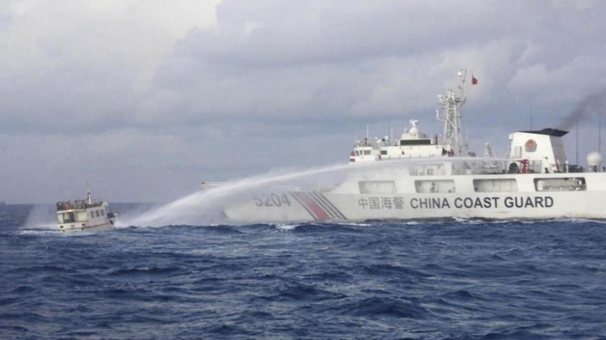 A Chinese Coast Guard ship uses water cannons on Philippine navy-operated supply boat M/L Kalayaan as it approaches Second Thomas Shoal, l
