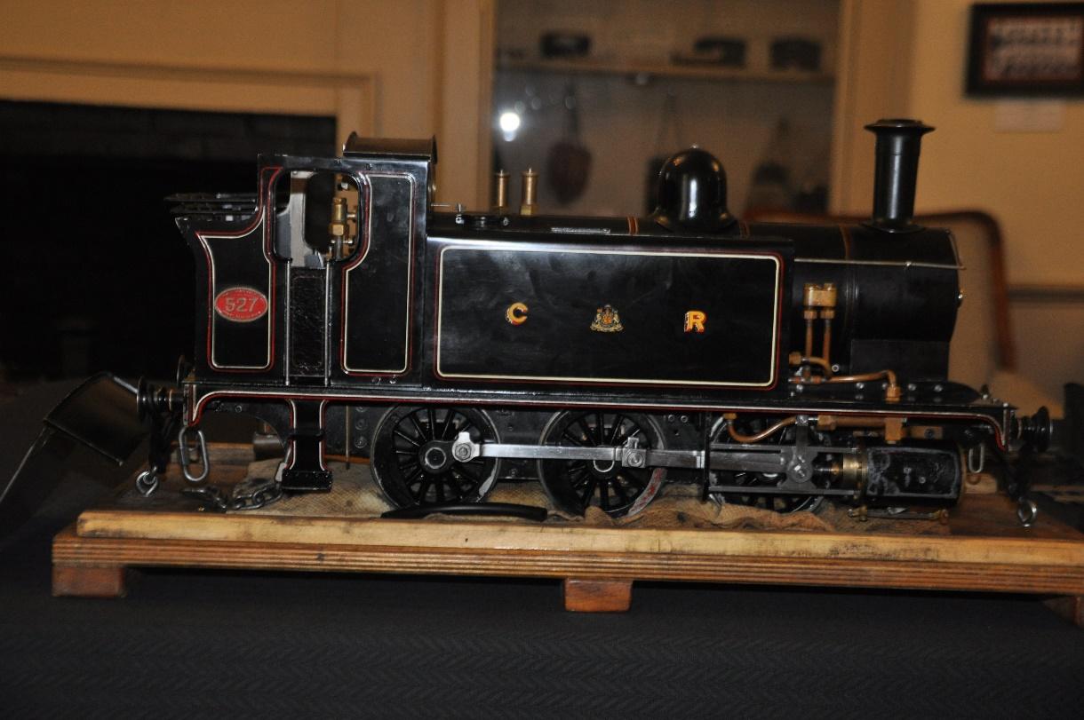 A model of a train on a wooden surface

Description automatically generated