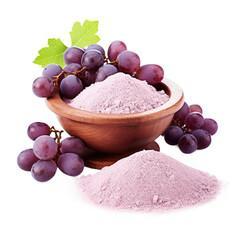 Grape powder and fresh grapes in a wooden bowl on a transparent backround.