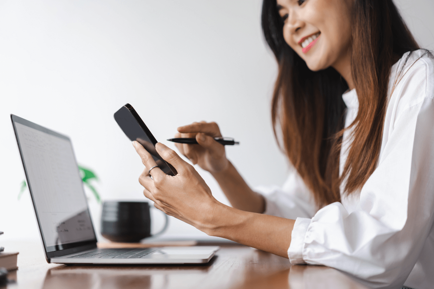 a woman using her laptop and phone