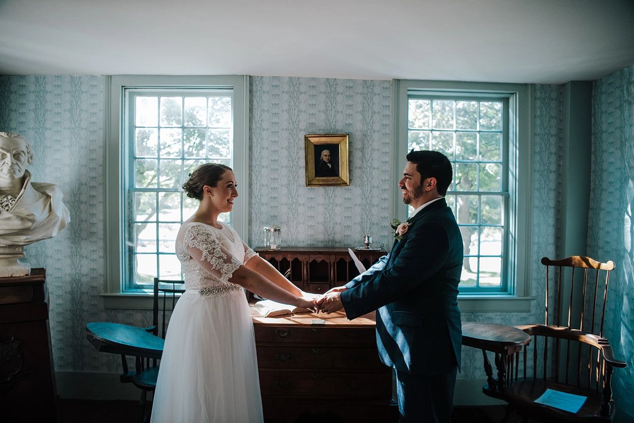 Bride and Groom holding hands looking at each other