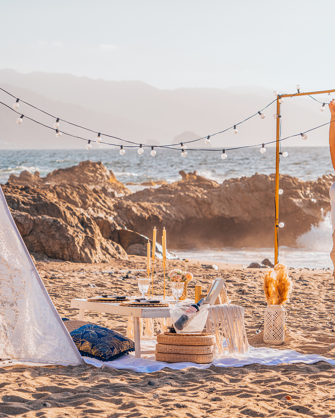 A couple enjoying a romantic picnic on the beach in Puerto Vallarta.