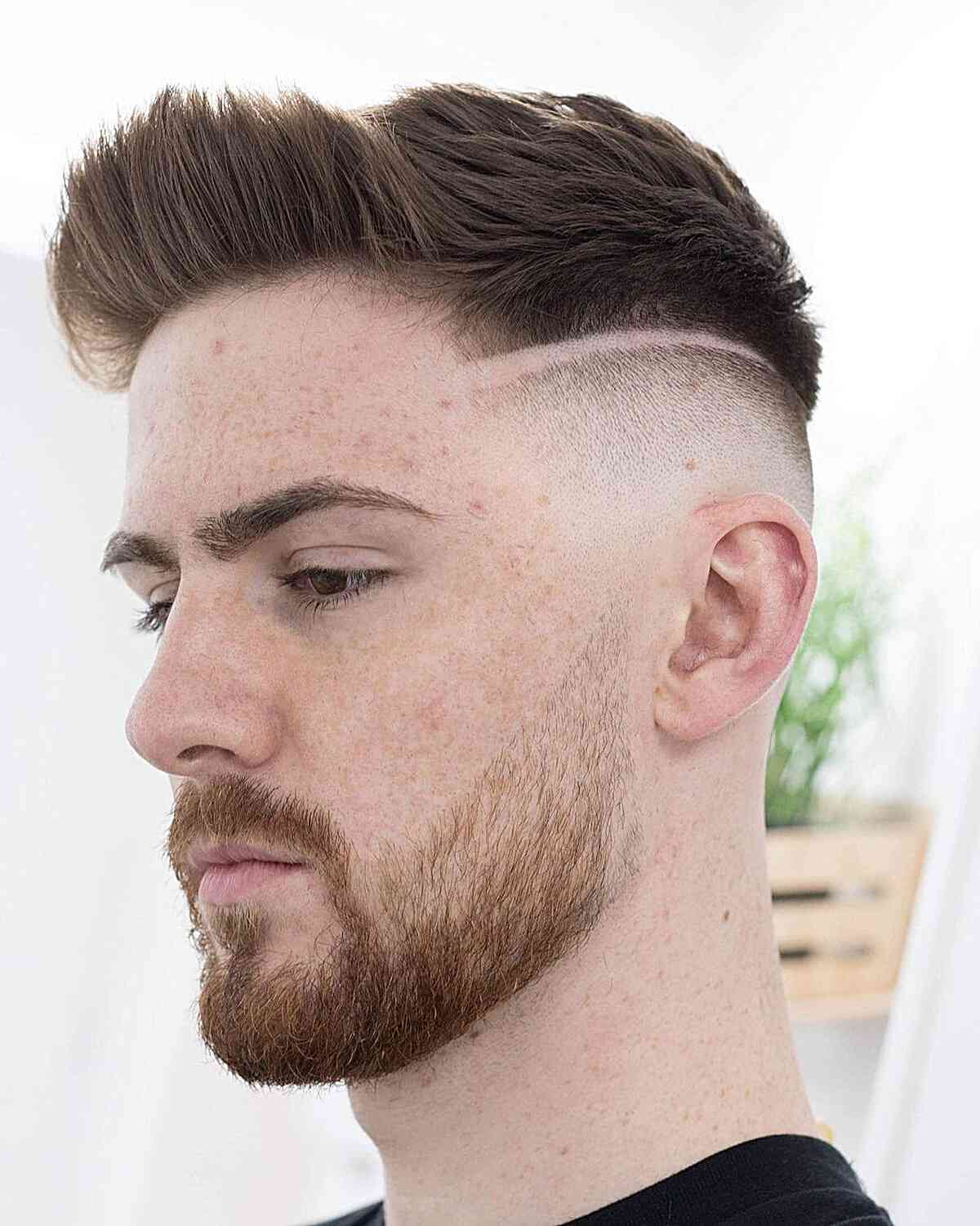 Picture of a guy wearing the hairstyle with a shaved line 