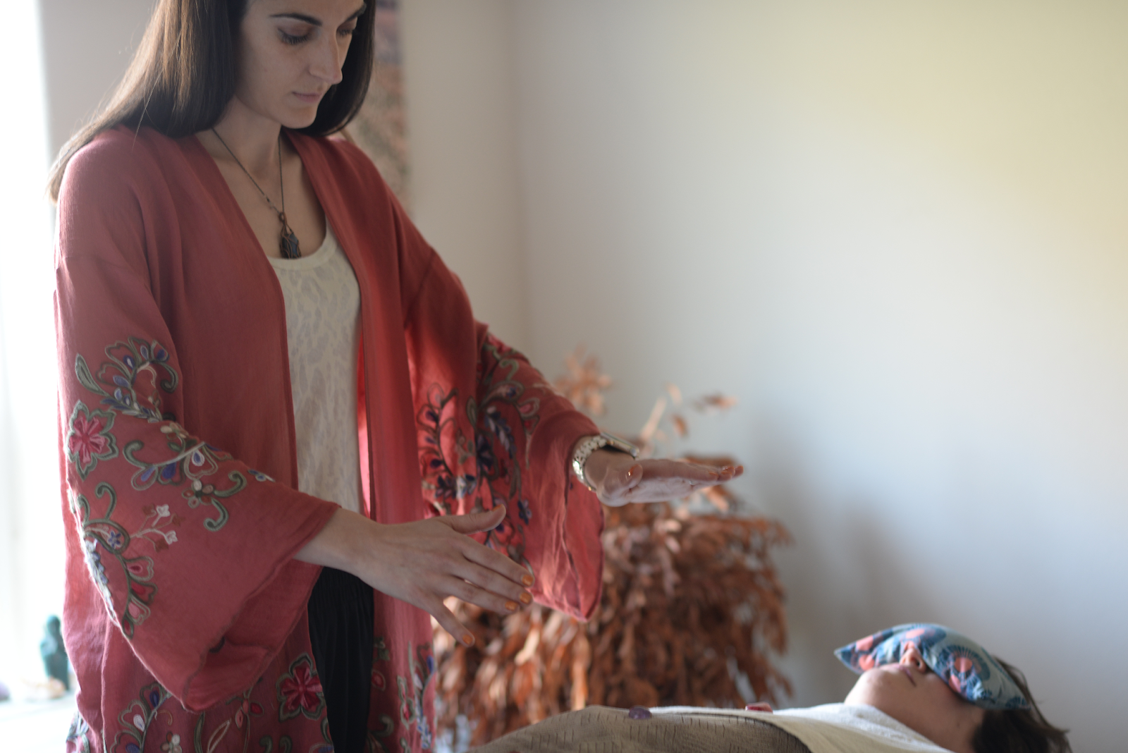 Reiki master perfoming Reiki on her patient to balance chakras.