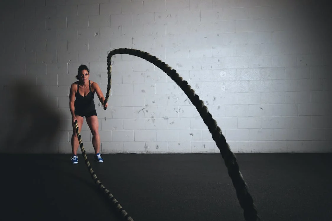 A woman holding exercise ropes