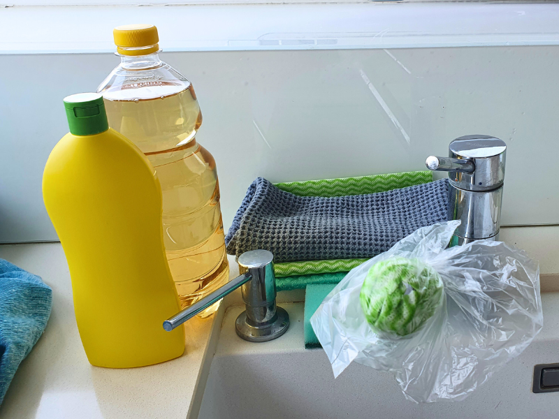 Ocot a citrónová šťava položené pri vodovodnej batérii.