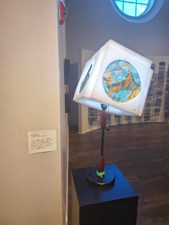 A lamp with a globe on it

Description automatically generated