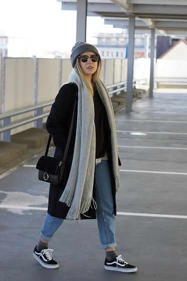 Picture showing  a lady accessorizing her outfit paired with the vans knu skool