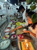 A group of people sitting at a table with food

Description automatically generated