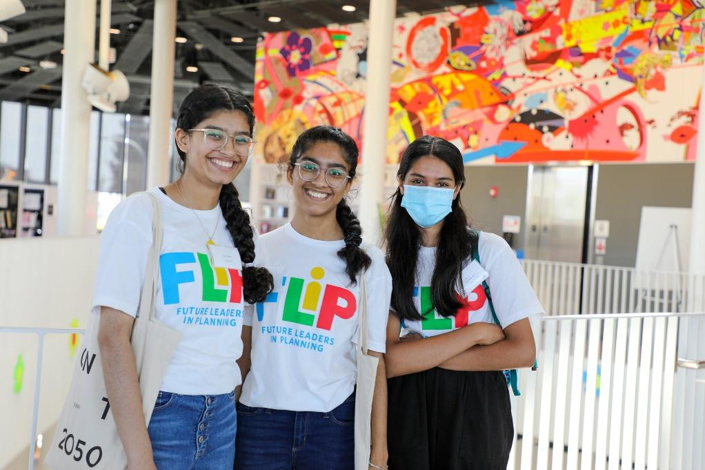 FLIP students pose at the Chinatown library with locally produced artwork in the background.