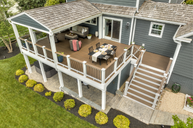 reasons to hire an experienced deck installer raised outdoor living space with dining area custom built michigan