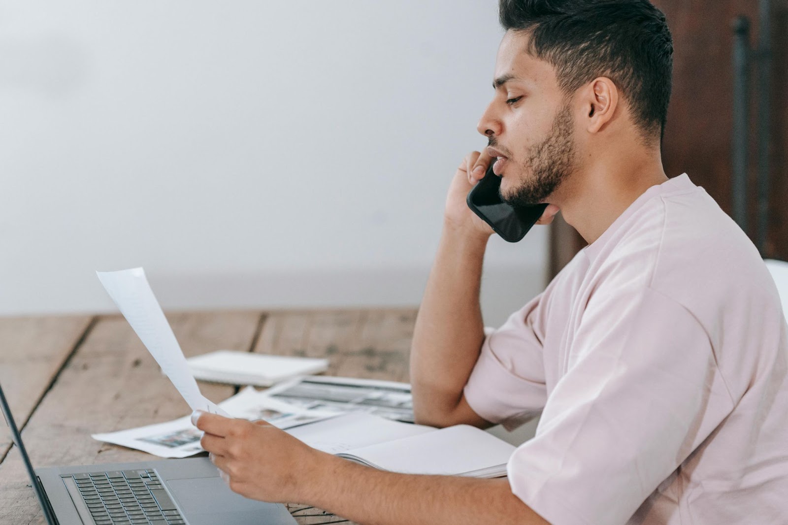 A man reading a document and receiving a fraud alert