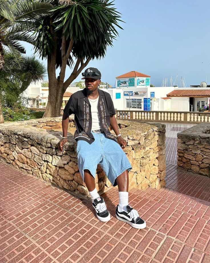 Picture showing a guy dressed in short baggy jeans rocking the sneakers
